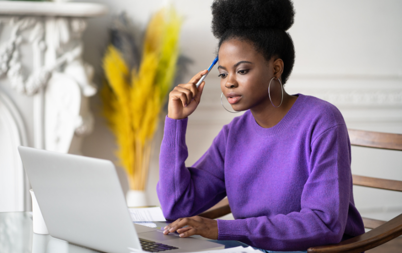 Focused entrepreneur researching Amazon seller tips on a laptop, planning strategies for a successful online business.